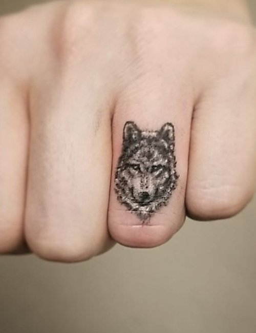Wolf tattoo on finger