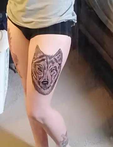 Wolf tattoo on the thigh
