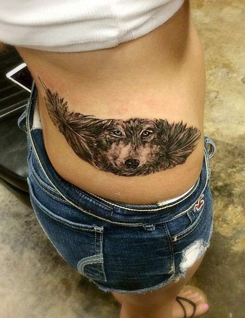 Wolf with feather tattoo