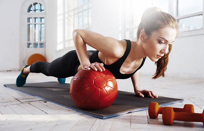 Medicine ball split push-up knee tuck exercise