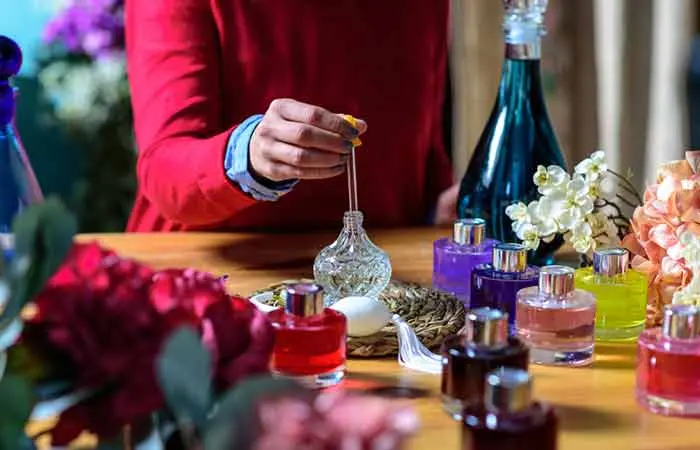 A woman preparing perfume in flasks