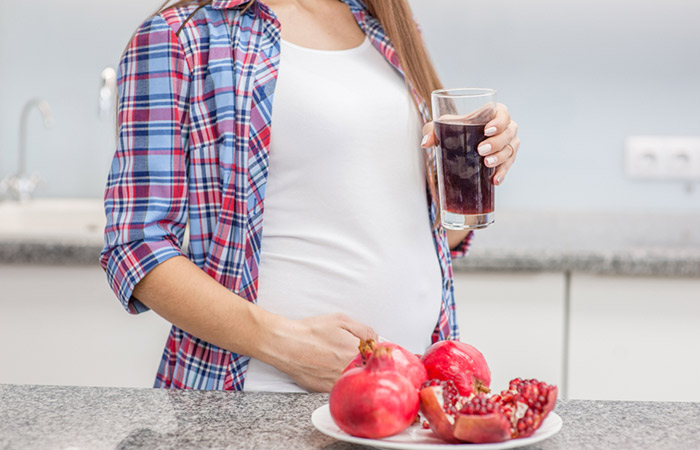 Pregnant woman drinking pomegranate juice