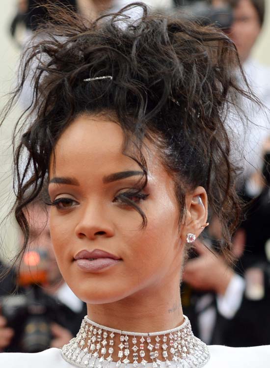 Rihanna sporting a black messy updo