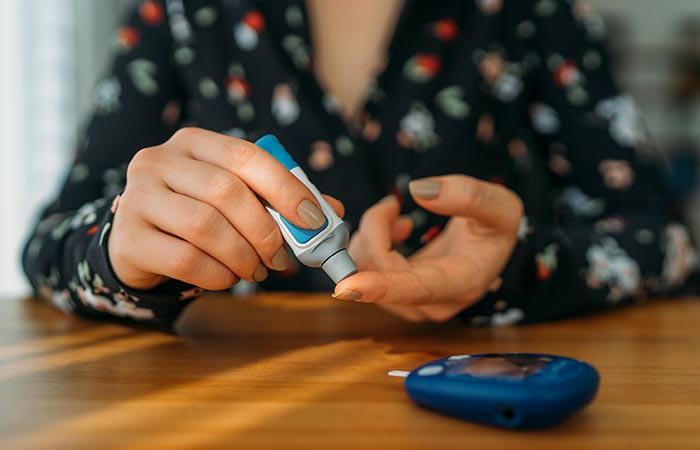 Woman with diabetes checking blood sugar level