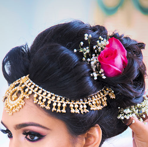 Dramatic center parted bun Indian bridal hairstyle
