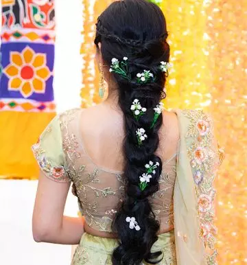 Floral curly fishtail braid Indian bridal hairstyle