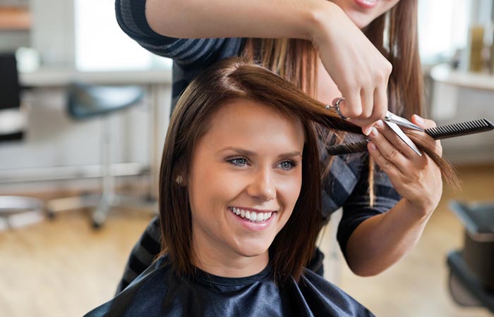 Woman cutting her split ends at a salon