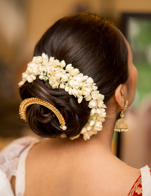 Gold floral bun Indian bridal hairstyle