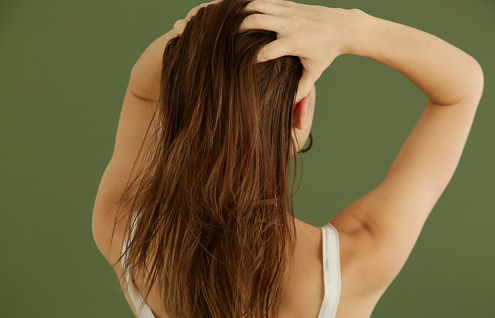 Woman massaging oil on her hair
