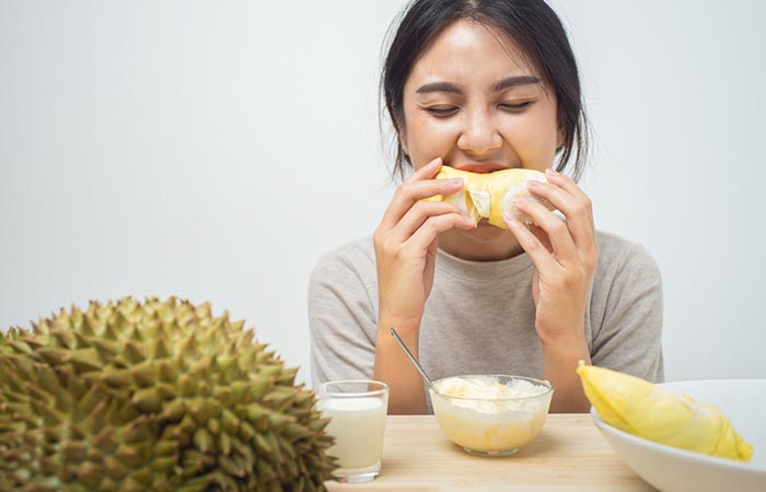 Woman eating durian fruit