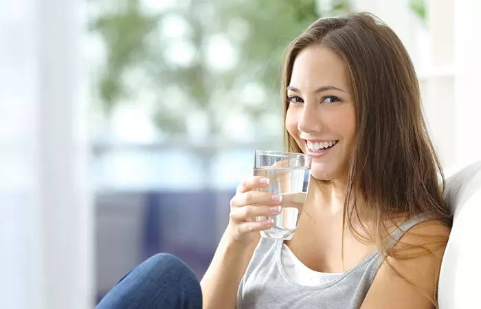 Woman drinking water to increase estrogen levels