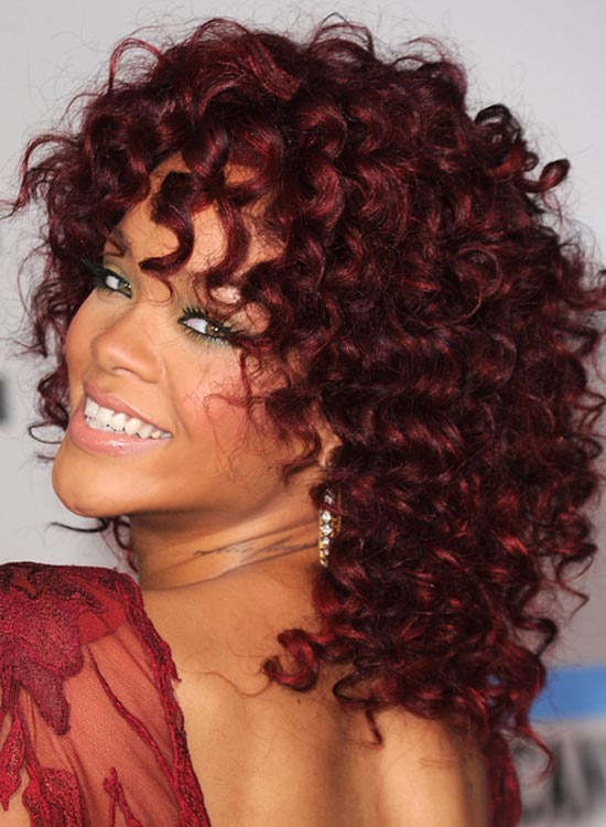 Rihanna sporting a maroon curly bob hairstyle