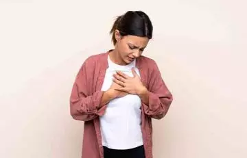 Woman having chest pain due to heart disease
