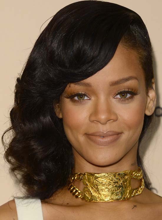 Rihanna sporting a side shaved medium hairdo