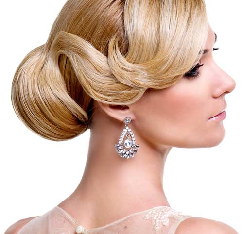 Side-swept bangs bun bridal hairstyle for round face
