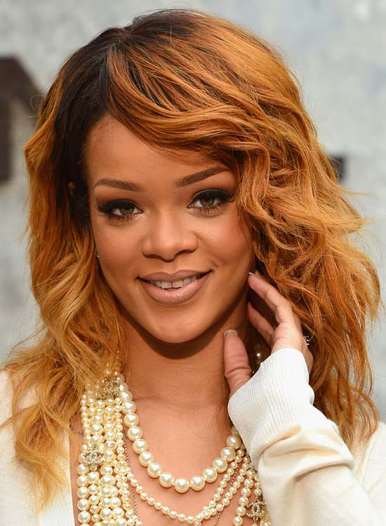 Rihanna sporting her side swept burgundy waves hairstyle