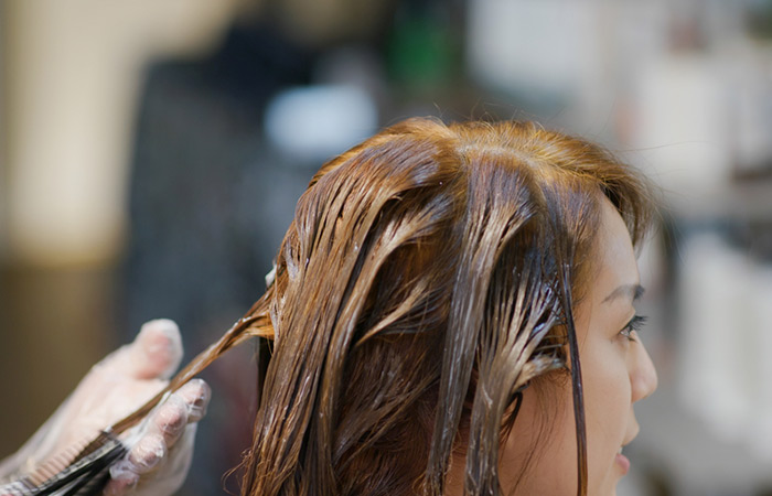 Chemical hair smoothening process at salon