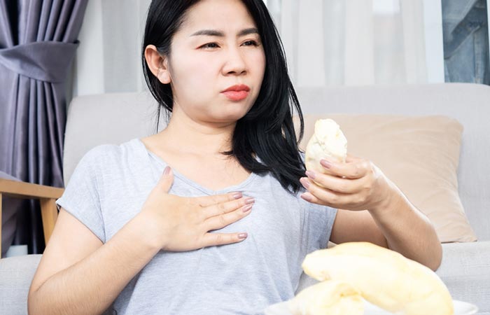 Woman feeling discomfort after having durian fruit
