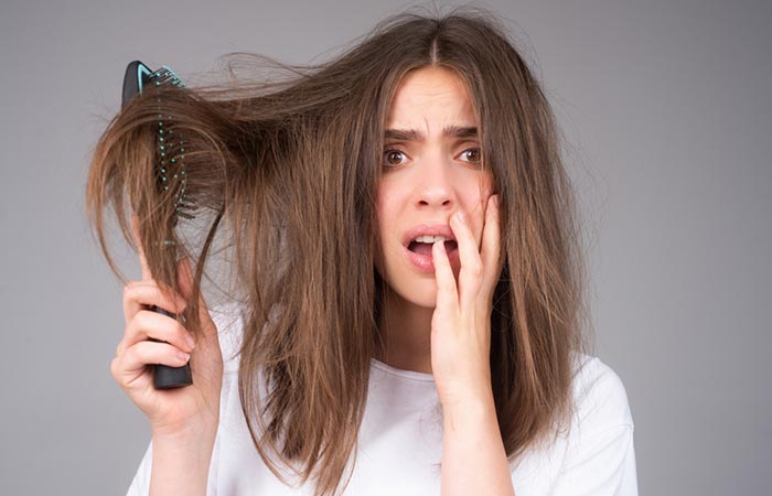 Woman worried with her frizzy hair 