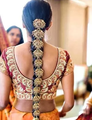 Pleated and jewelled South Indian hairstyle for girls