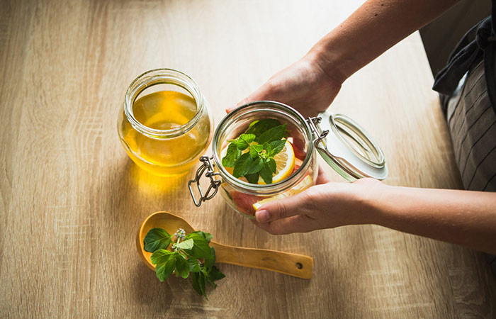 Woman preparing lime and honey water for weight loss