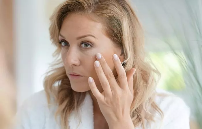 Woman checking aging signs on her face