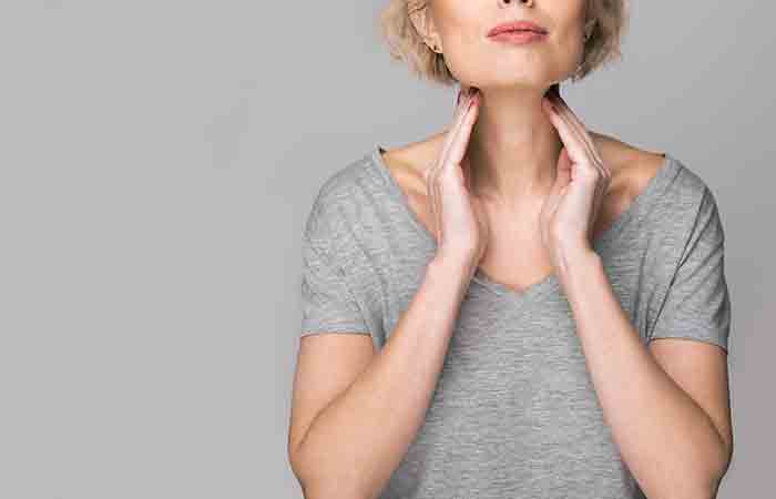 Woman holding her neck due to sore throat
