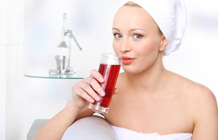 Woman drinking grape juice for glowing skin