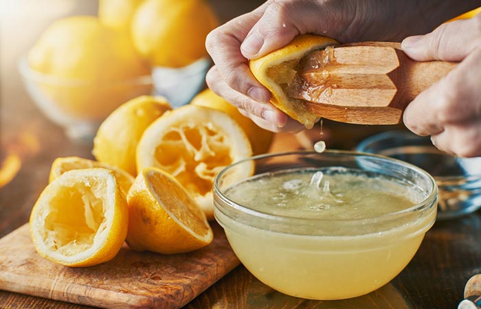Hands squeezing lemon to make lemon water