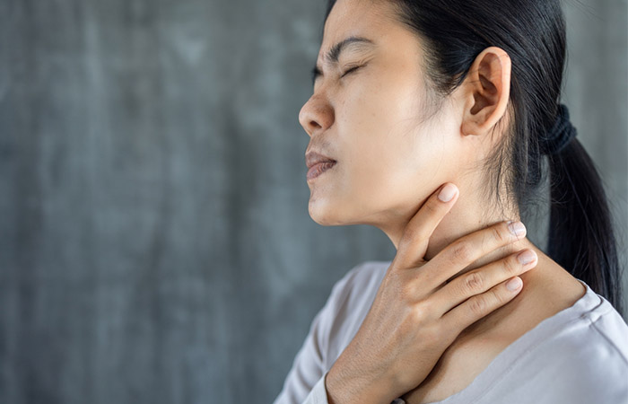 Woman experiencing sore throat and coughs may find relief with a pomgranate peel remedy