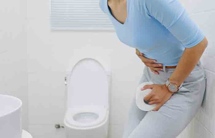 Woman with constipation in the washroom