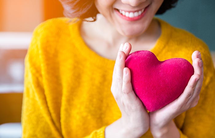 Woman holding pink heart to portray good heart health