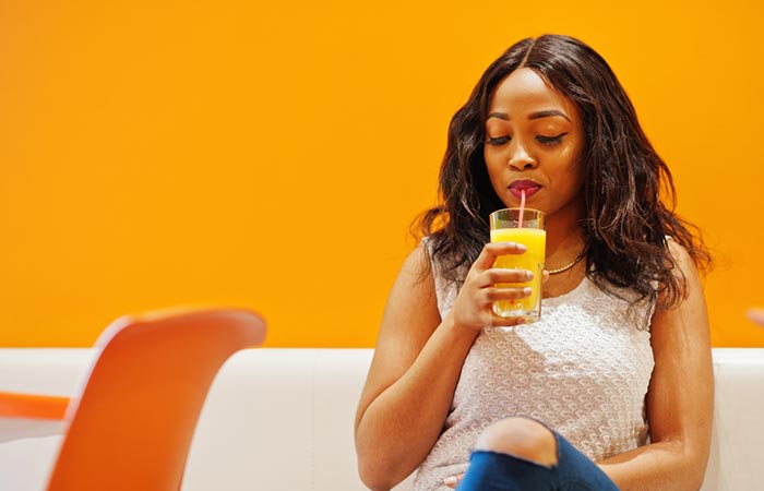 Woman drinking pineapple juice for glowing skin