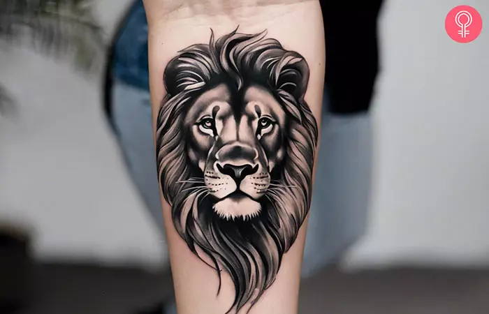 Black and gray lion tattoo on the forearm