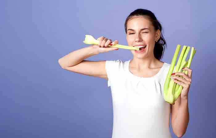Woman eating celery
