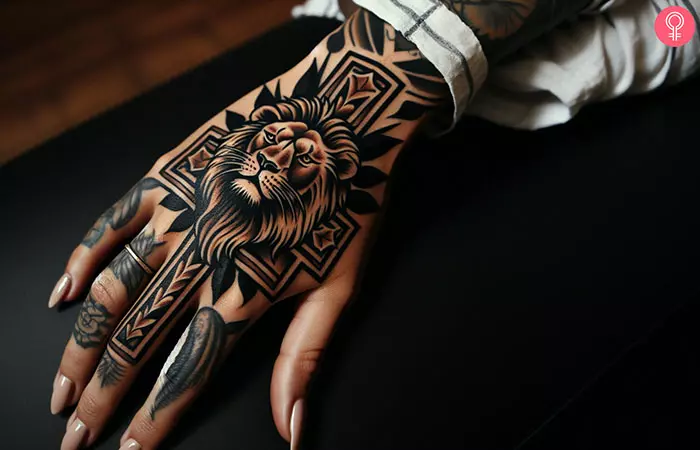 Woman with lion cross tattoo on her hand