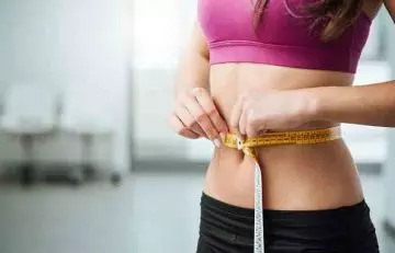 Yam benefits woman measuring her slim waist