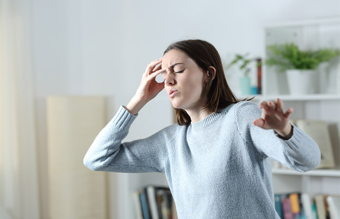 Woman feeling dizzy as a side effect of garlic