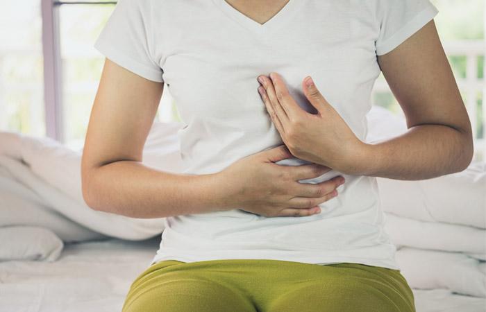 Woman suffering from GERD due to excess garlic consumption