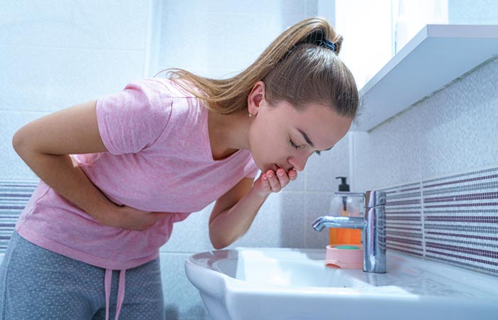 Woman vomitting as a side effect of having bitter gourd