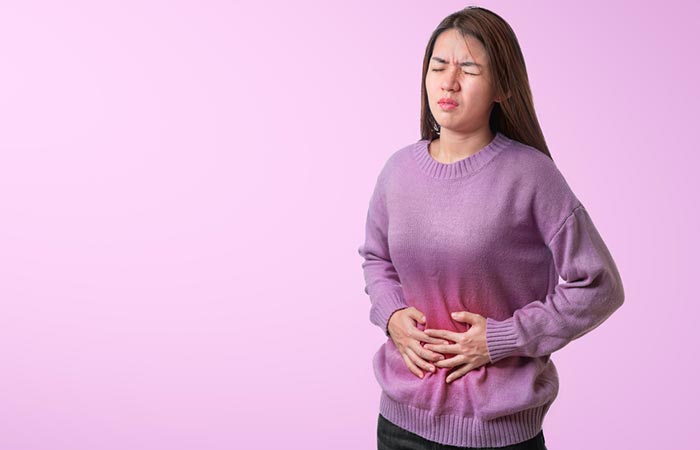 Woman holding stomach due to pain
