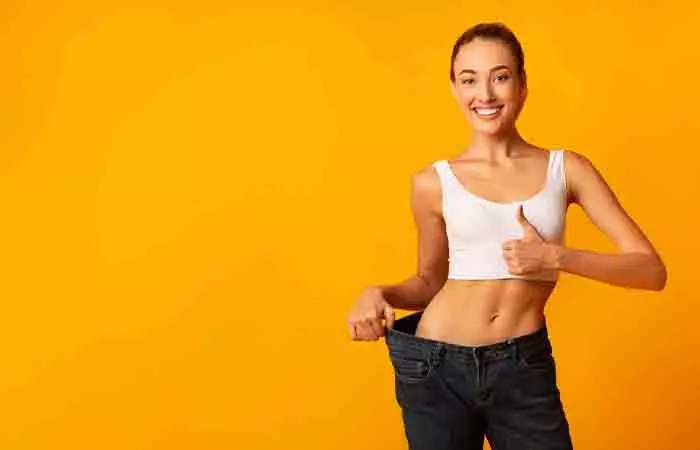 Woman in oversized jeans after weight loss