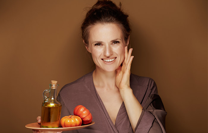 Woman using squash extracts to maintain a healthy skin
