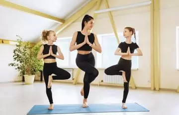 Women doing variations of the tree pose.