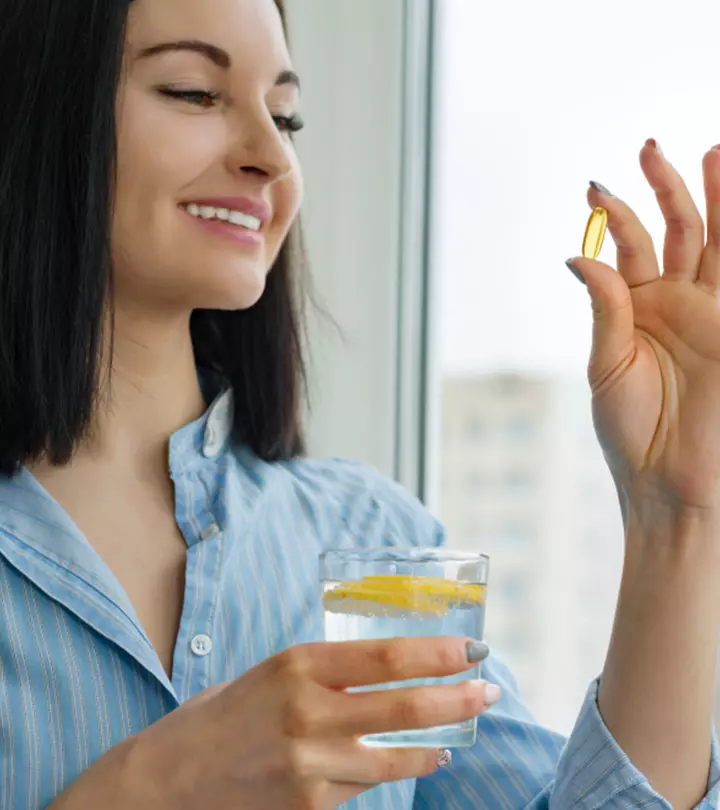 Woman Having Vitamin E Capsule
