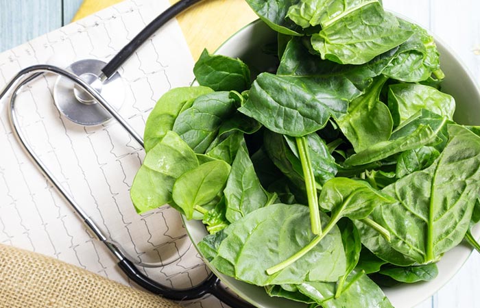 A stethoscope wrapped around a bowl of spinach