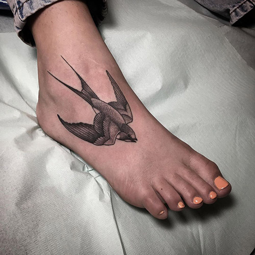Bird tattoo design on the foot