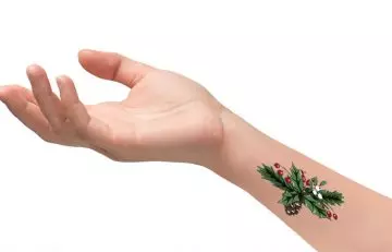 Colored holly tree tattoo on the wrist