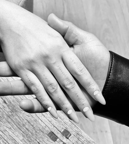 Dotted tattoo on Chrissy Teigen’s hand