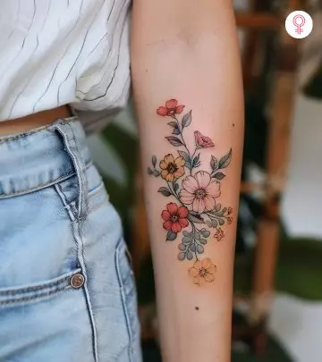 A woman with a colored cannon tattoo on her upper arm